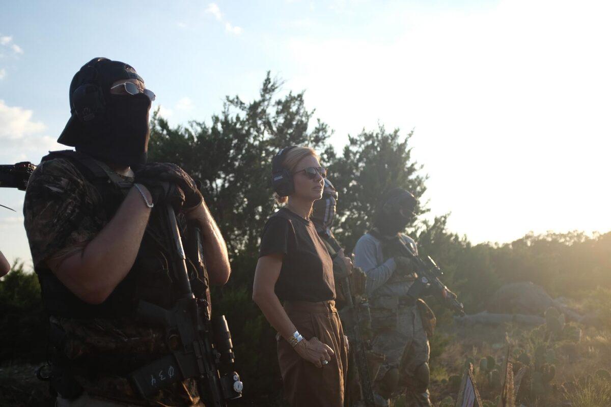 With armed group at sunset